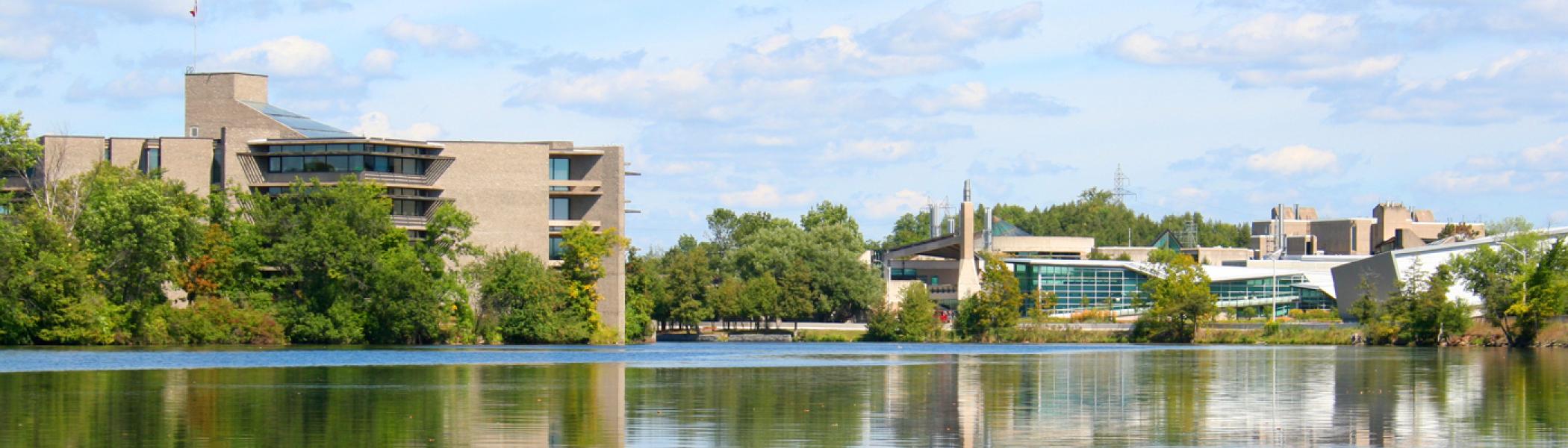 Trent University's Peterborough Campus from down-river highlighting Bata Library and the bridge.