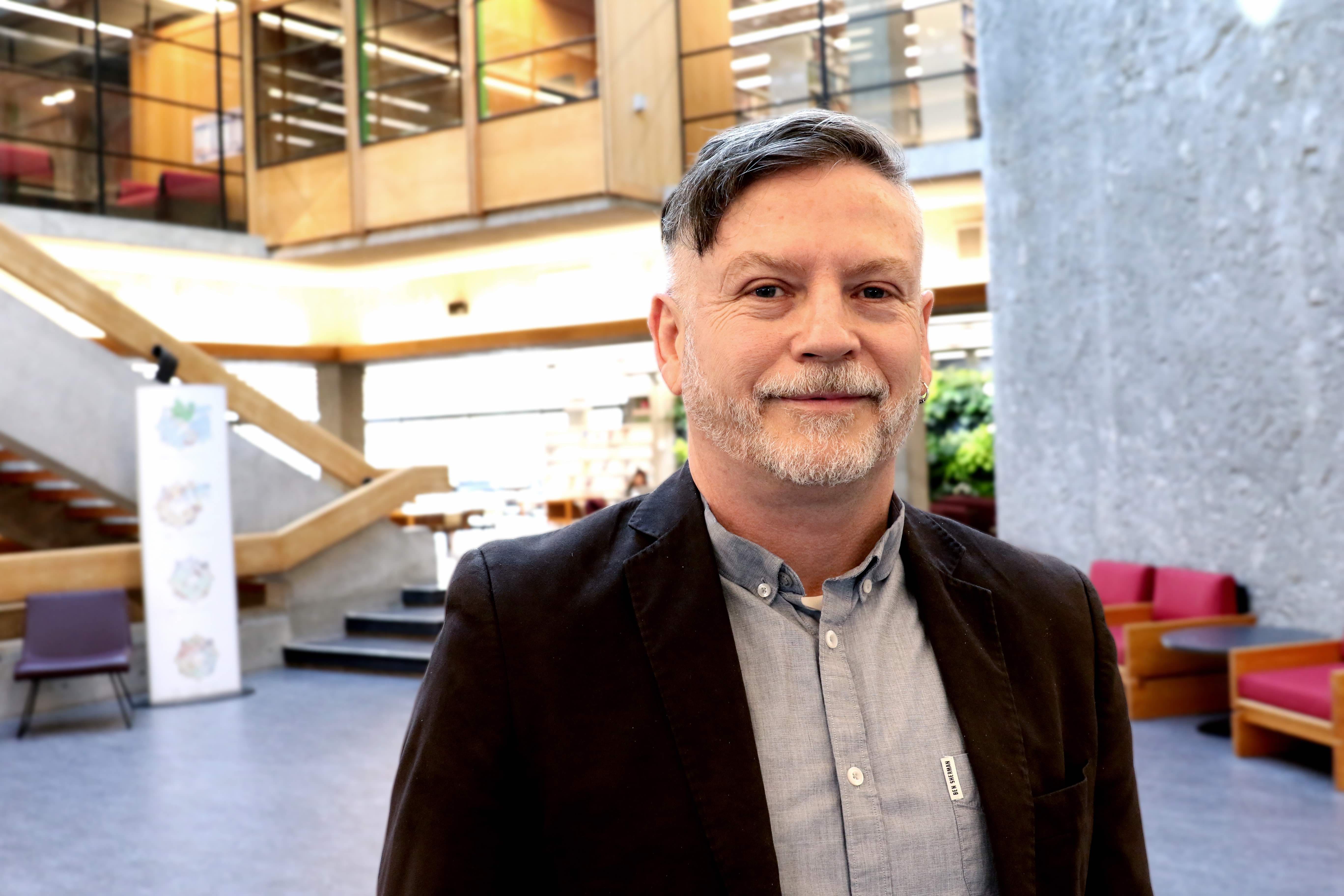 Fergal O'Hagan standing in Bata Library, posing for picture