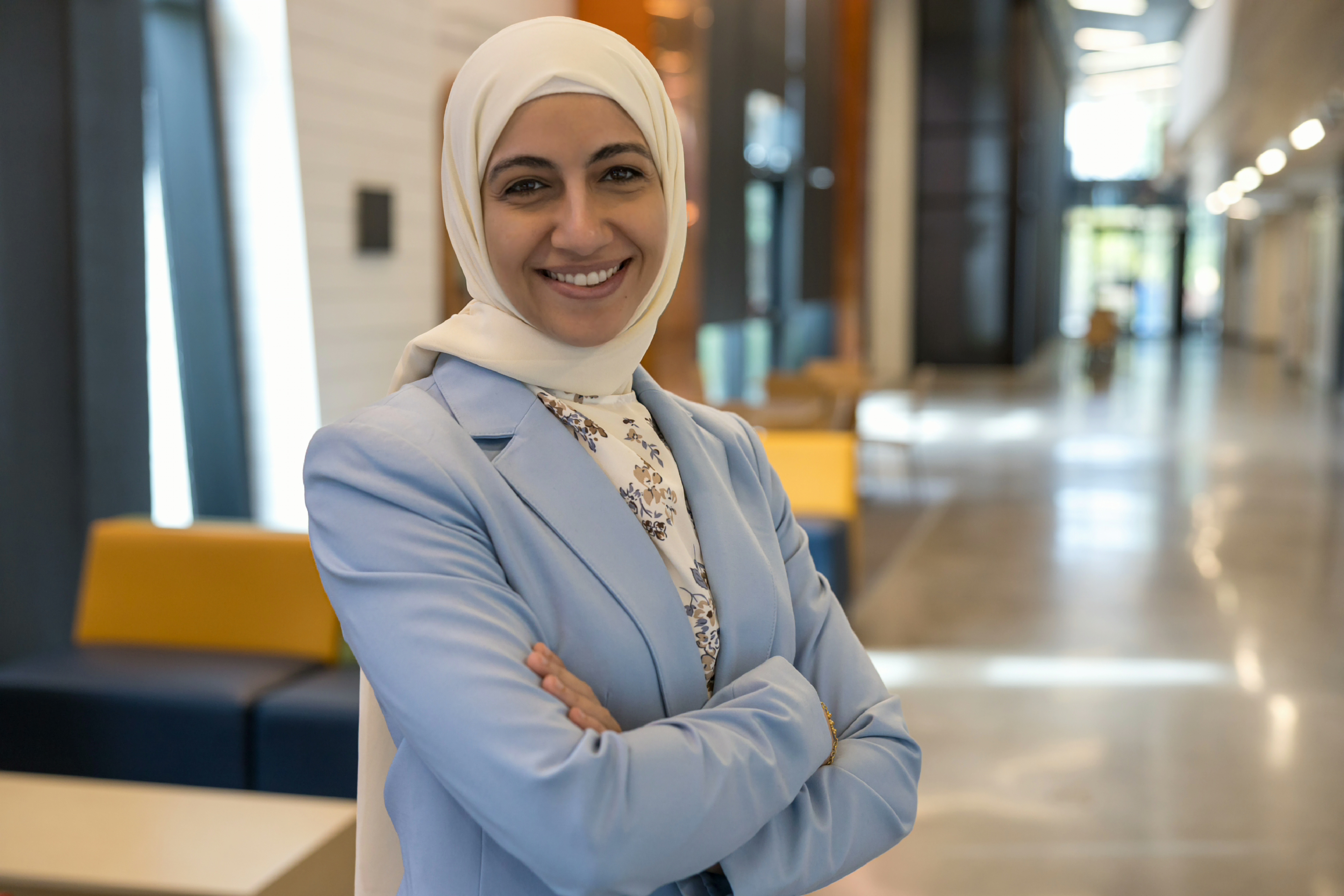Dr. Hammami standing with her arms crossed smiling at the camera