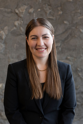 "Elizabeth Russell with stone wall background"
