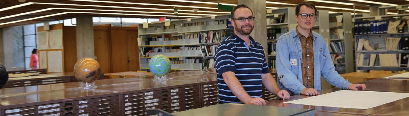 Trent Student and staff looking at Geography maps at Bata Library