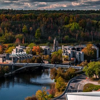 Aerial view of bridge and campus during fall