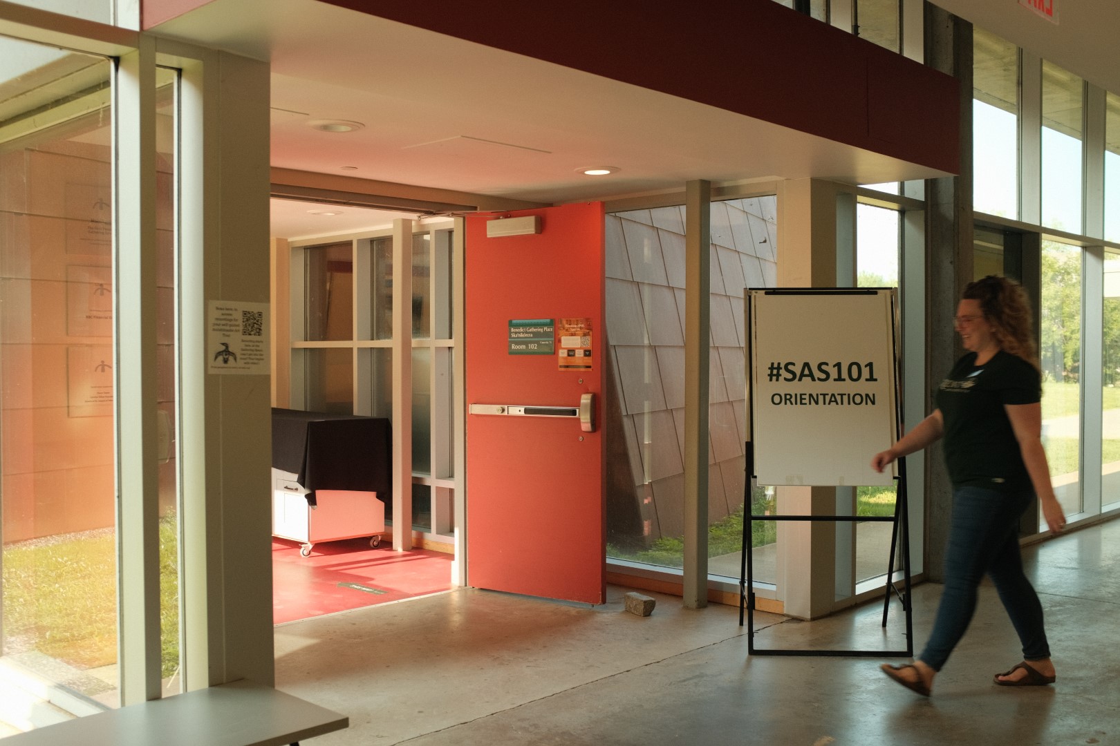 SAS Advisor Danielle walking into SAS101 summer orientation at the Gathering Space in GCS