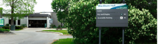 A white and grey building with a sign reading Blackburn Hall